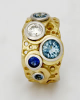 Large 'Loop Ring' in 18K gold with diamond, Aqua-marines and a blue sapphire